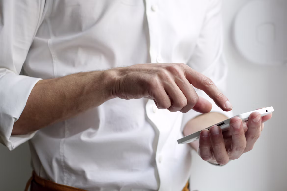 A verified TaskLync professional reviewing job details on their phone before starting work